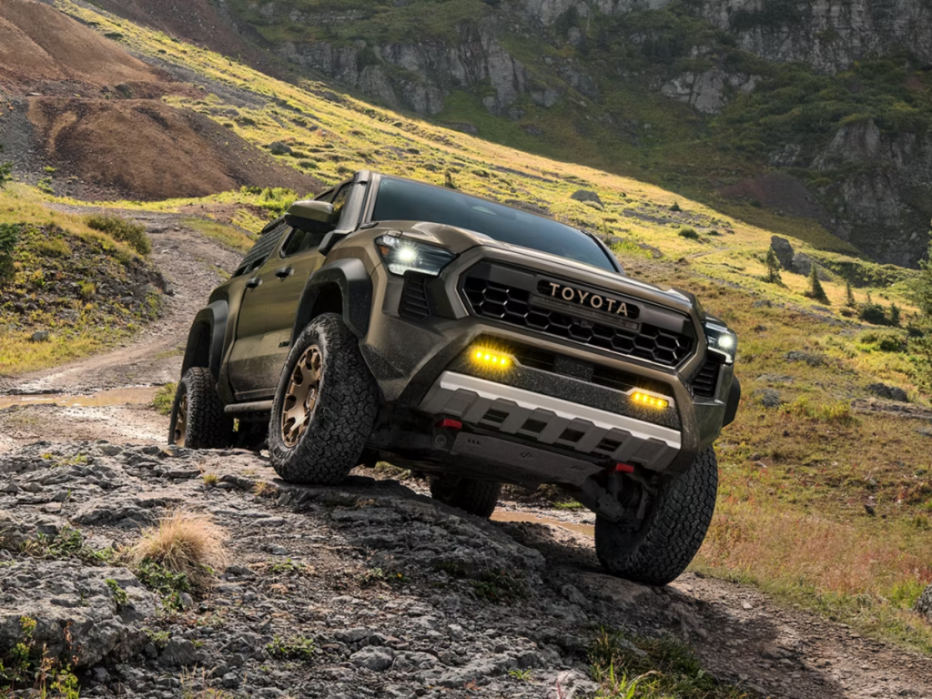 A 2026 Toyota Tacoma i-FORCE MAX tackling a steep incline in St. Louis, MO
