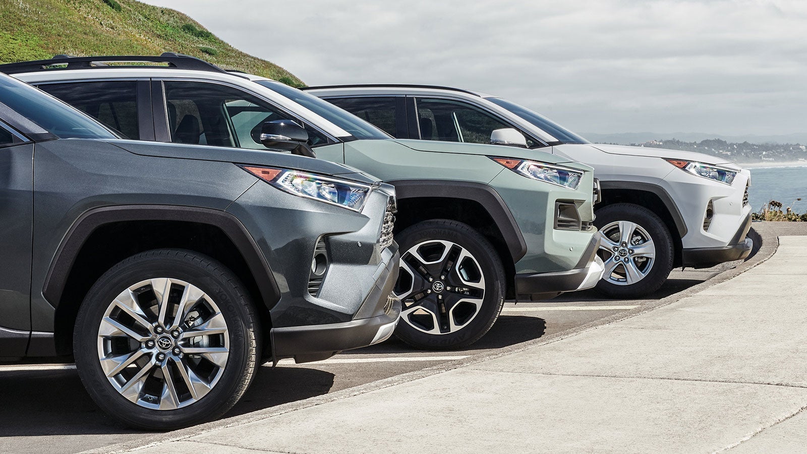 Three 2026Toyota vehicles on display beside a lake
