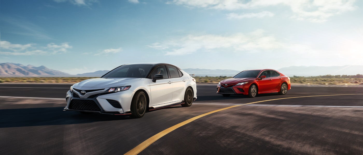 Two 2020 Toyota Camry TRDs driving on an open track