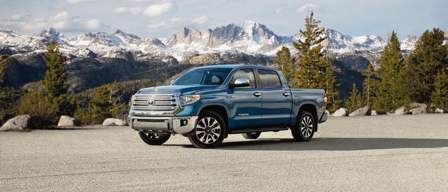 A blue 2020 Toyota Tundra parked in front of the mountains